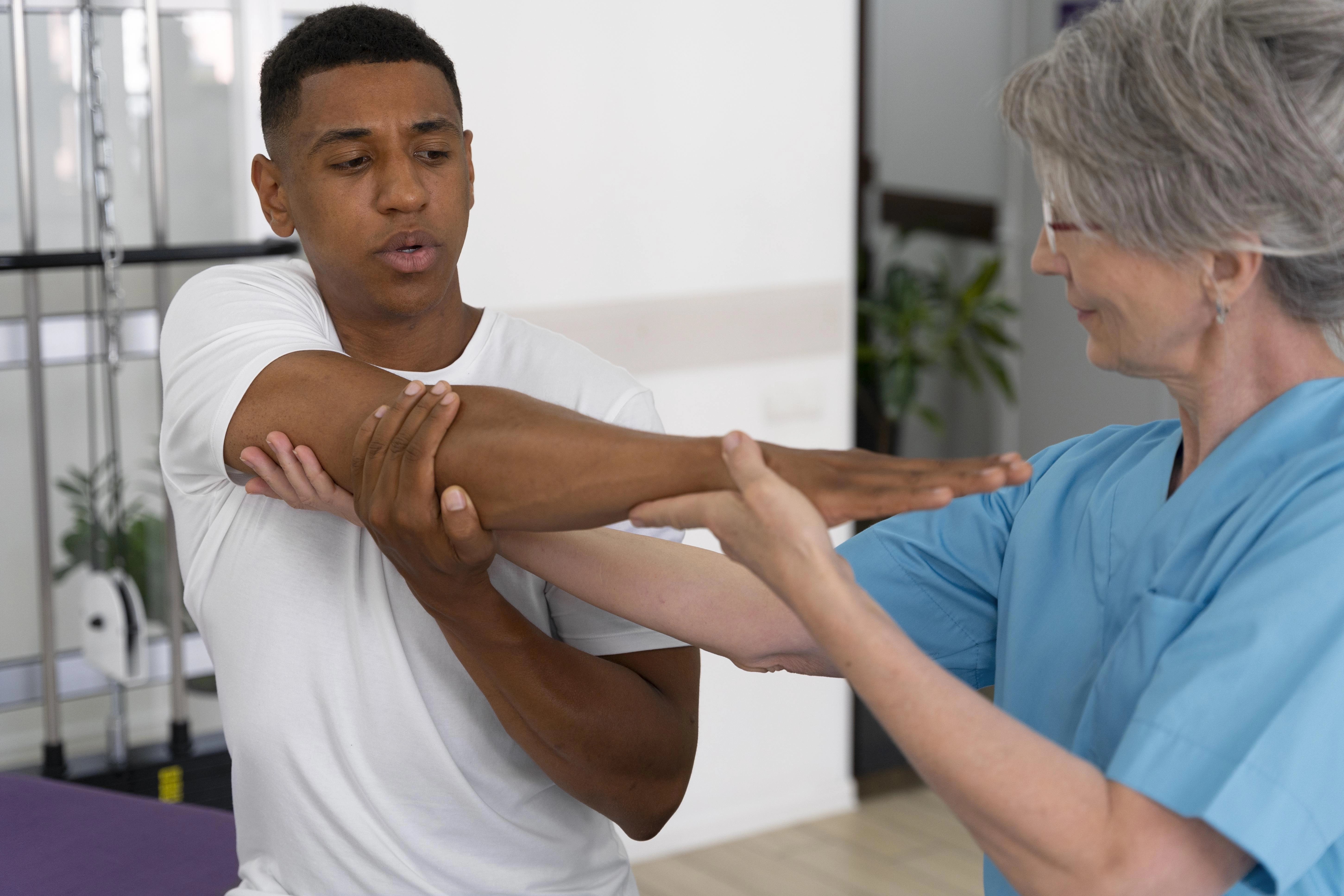 medical-assistant-helping-patient-with-physiotherapy-exercises