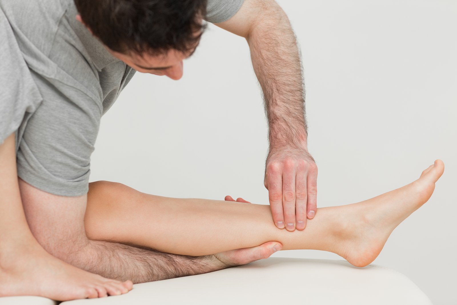 bigstock-Serious-osteopath-massaging-th-39351412