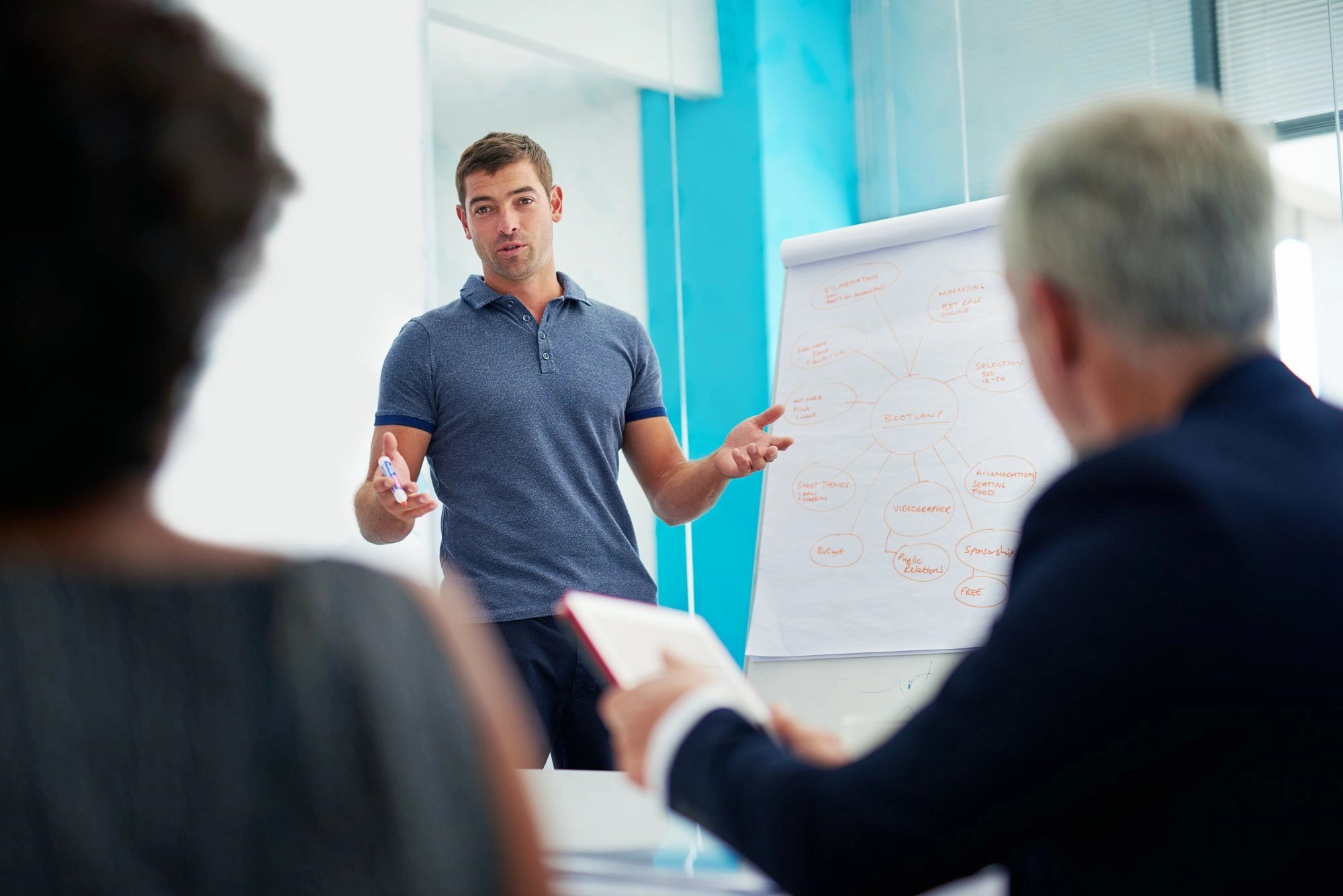 afternoon-strategizing-cropped-shot-young-businessman-giving-presentation-boardroom
