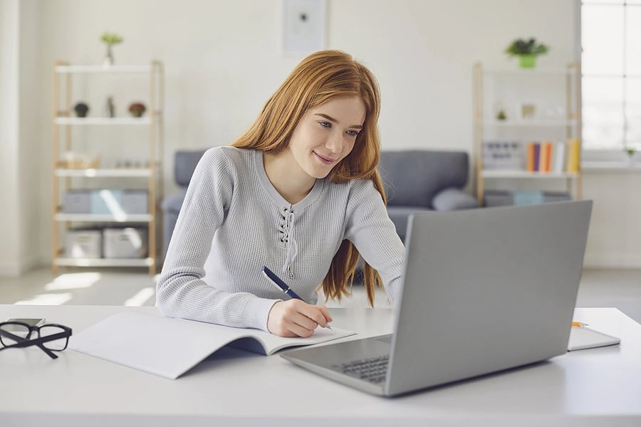 Young lady studying at her laptop computer