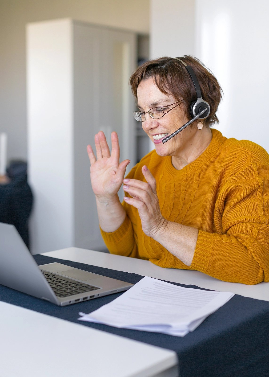 Woman with a headset on sitting at computer