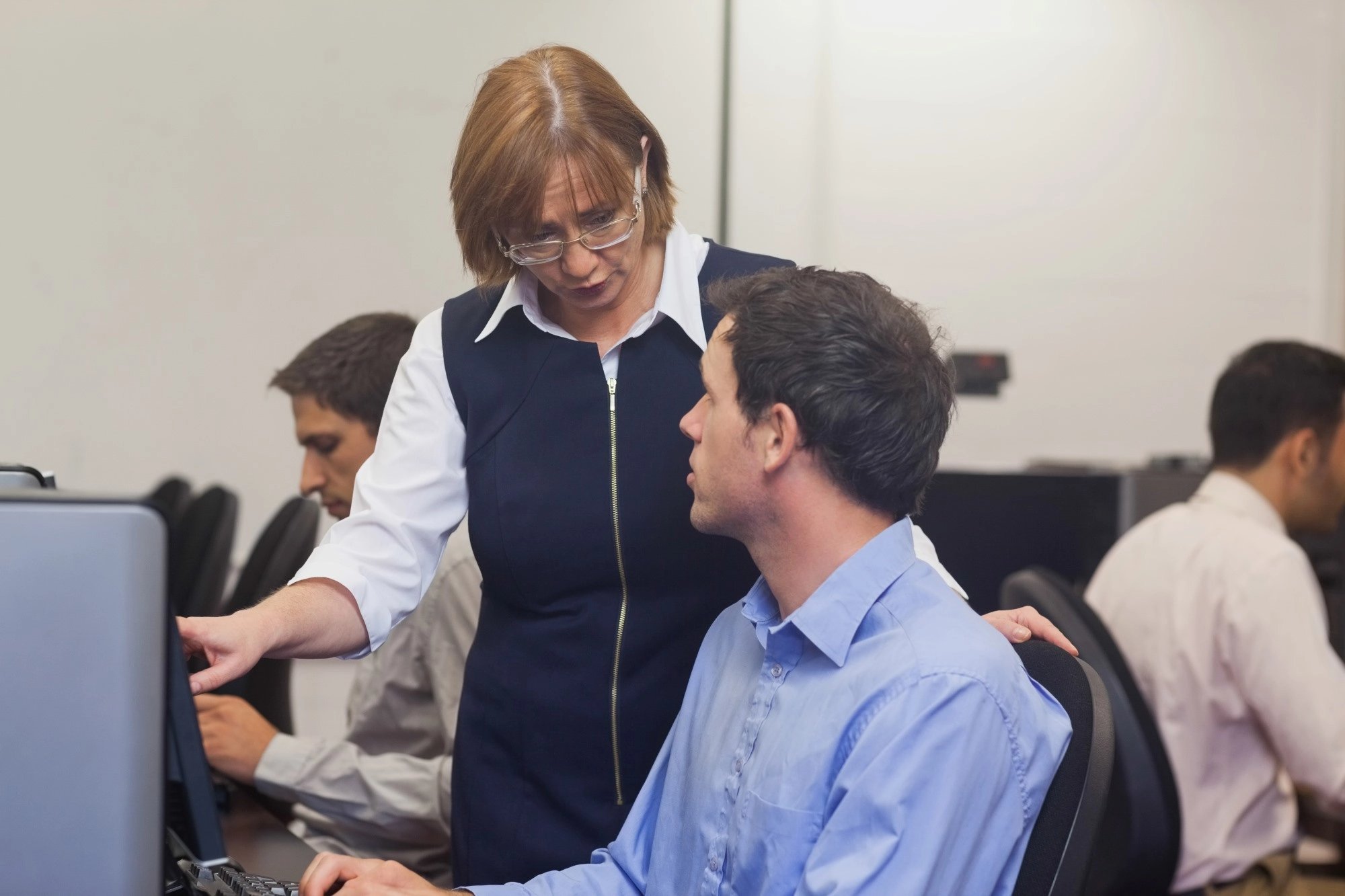 Female manager talking to office colleague