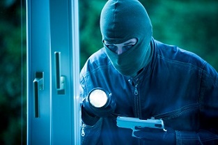 Burglar breaking into a building