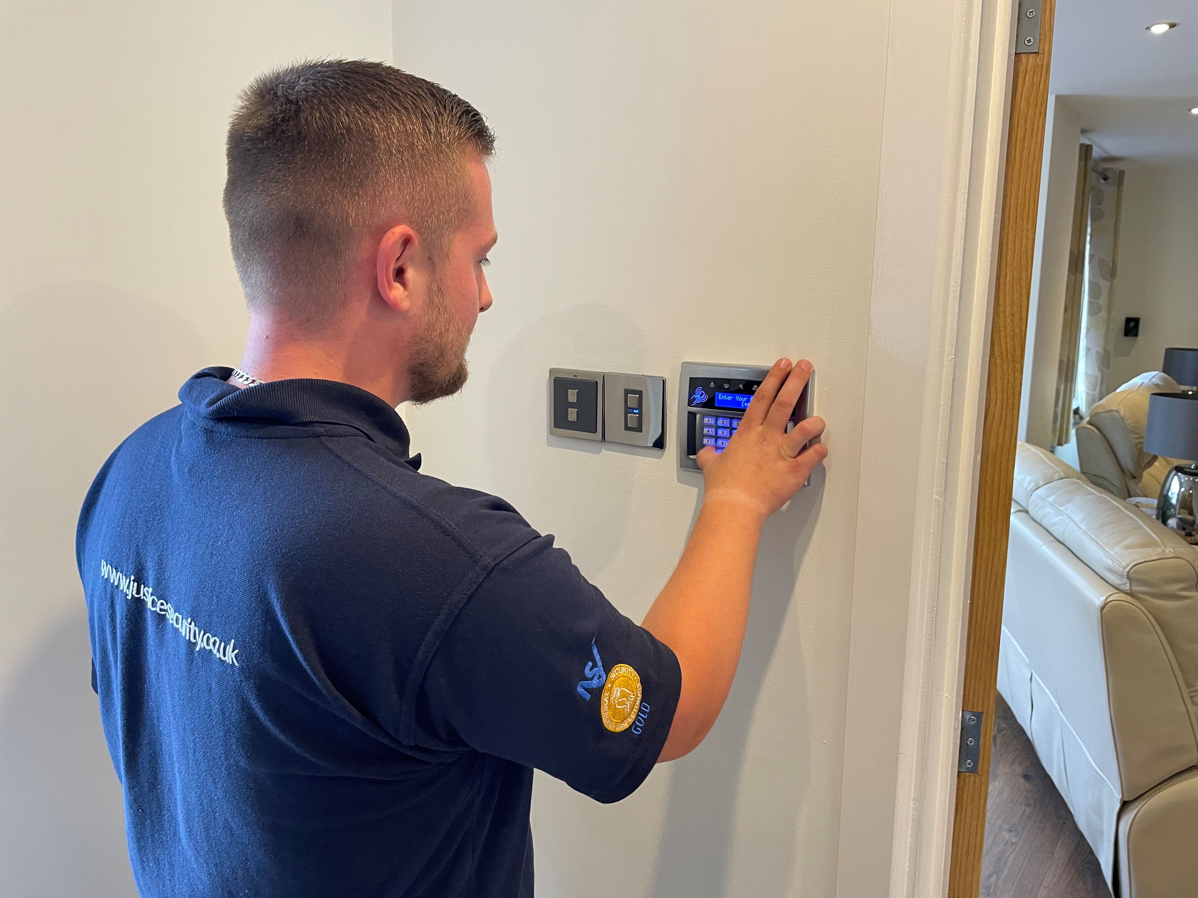 intruder-alarms/Engineer working on domestic keypad