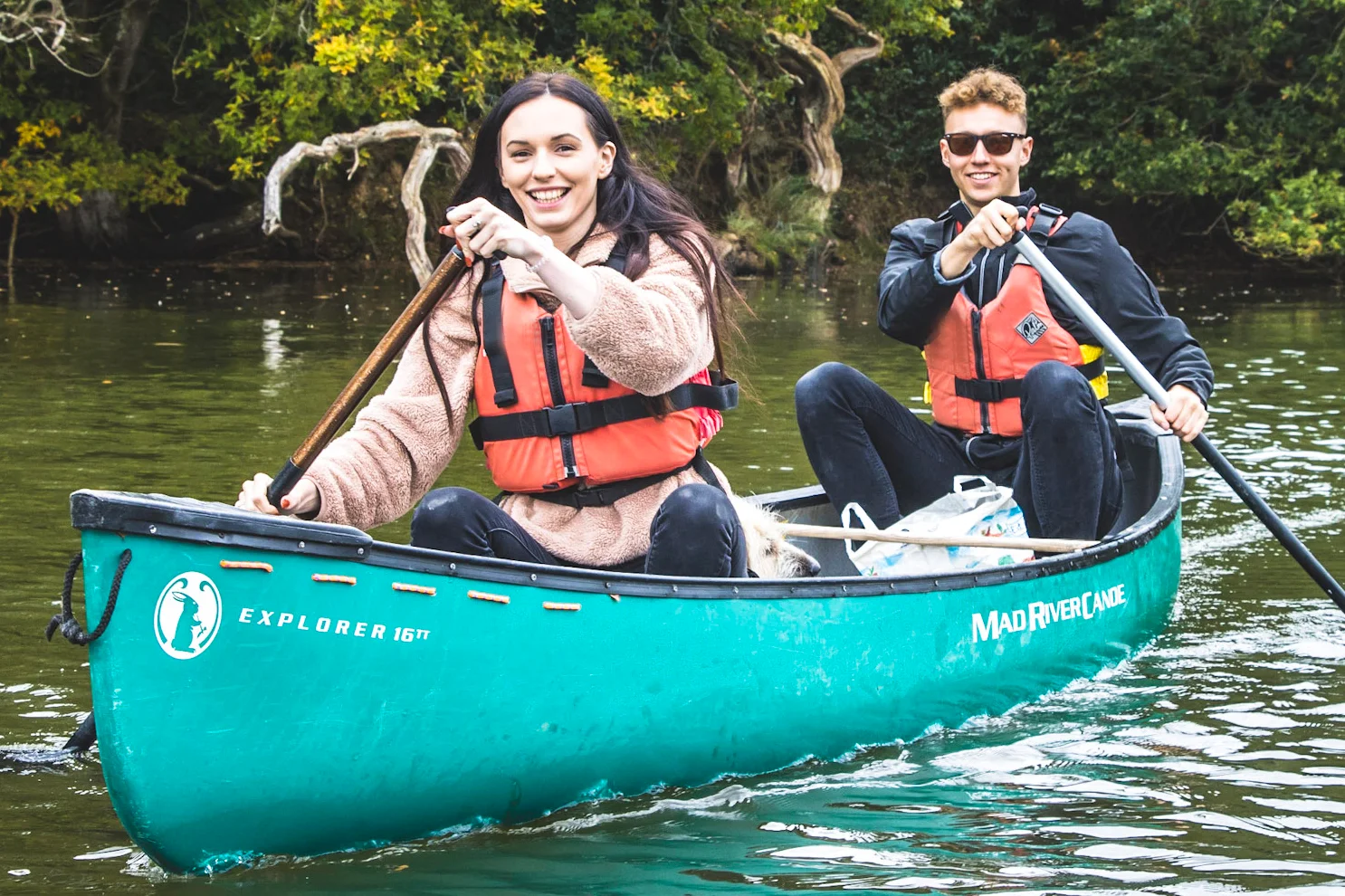 A couple enjoying a guided canoeing session on the River Spey