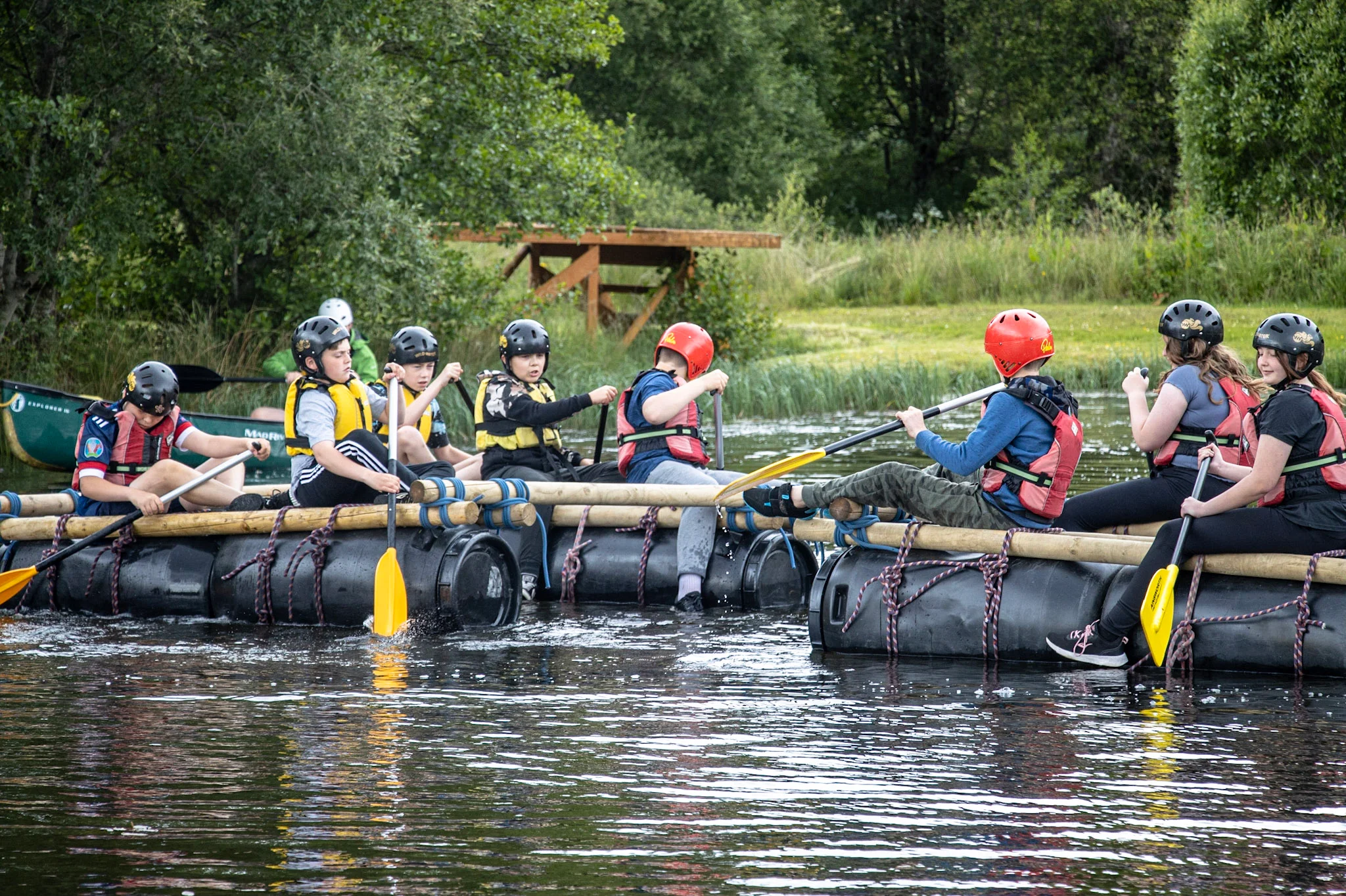 Pupils working together during raft building on a school residential