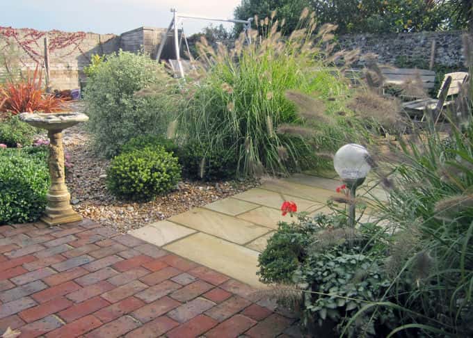Grasses sway in the sea breeze in a stylish seaside garden