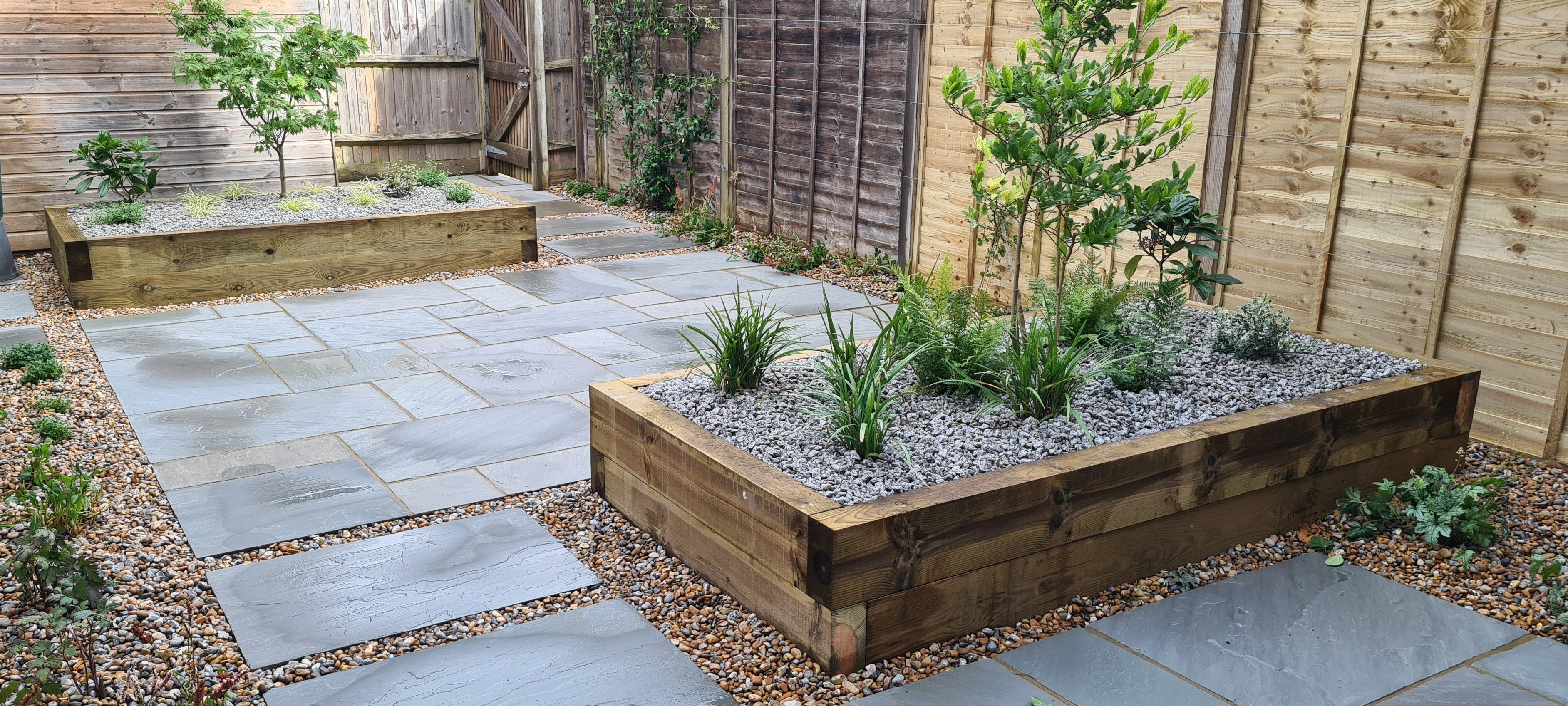 Drought tolerant garden with paving and gravel flowerbeds 