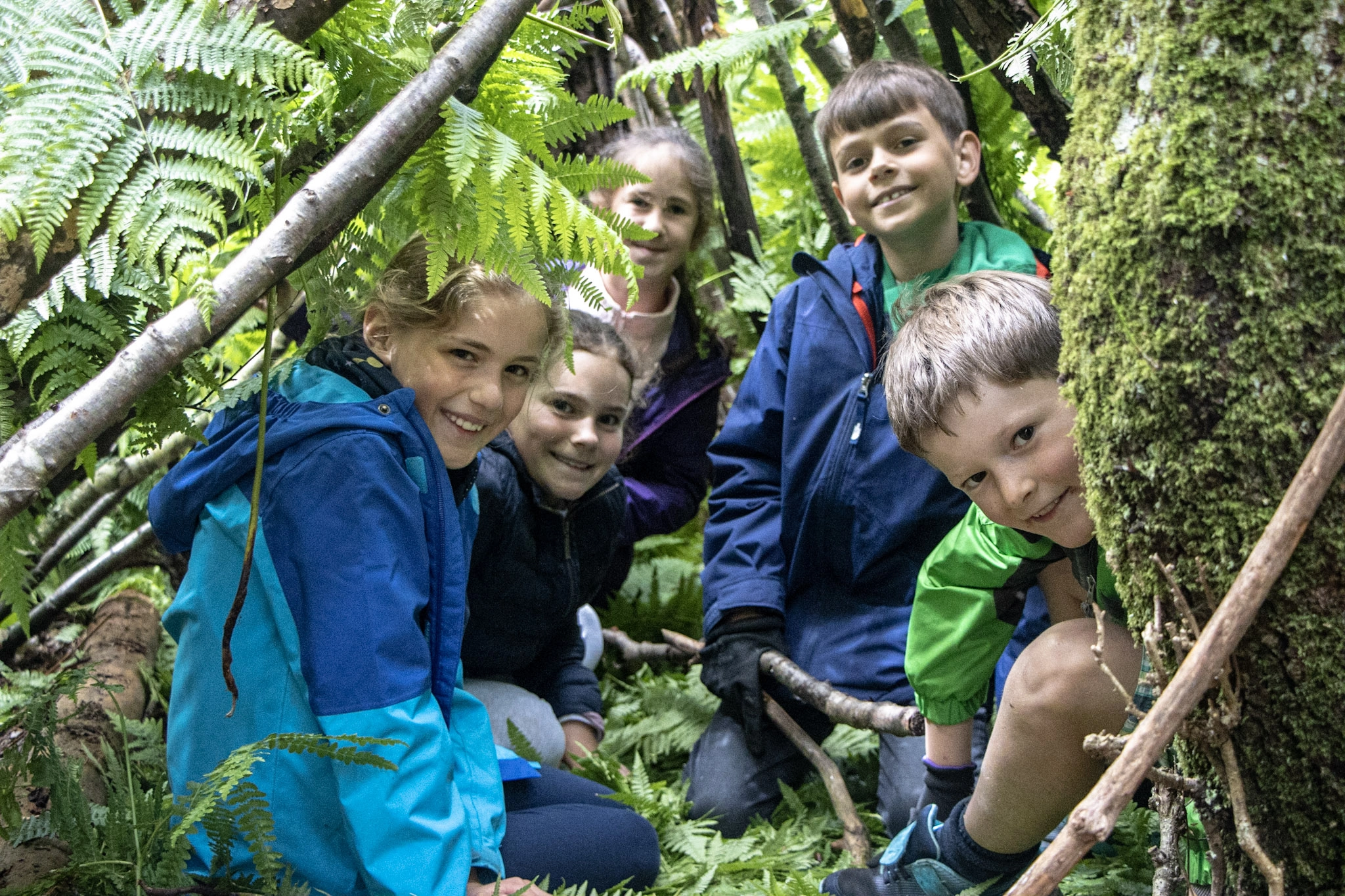 Children enjoying a woodland holiday club in the New Forest