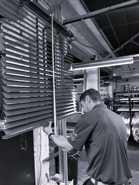 inspecting wooden venetian blinds