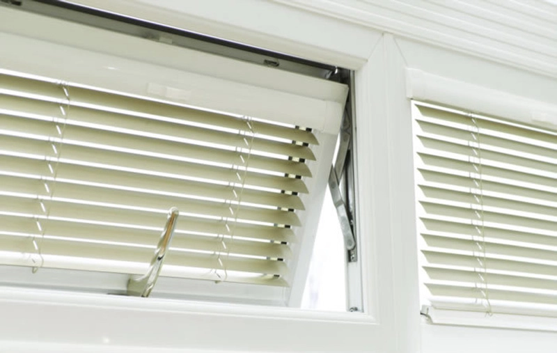 Window with integrated blinds partially open, showcasing a clean, white frame.