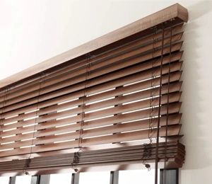 Wood blinds with a warm brown finish, partially open, showcasing a modern window treatment.