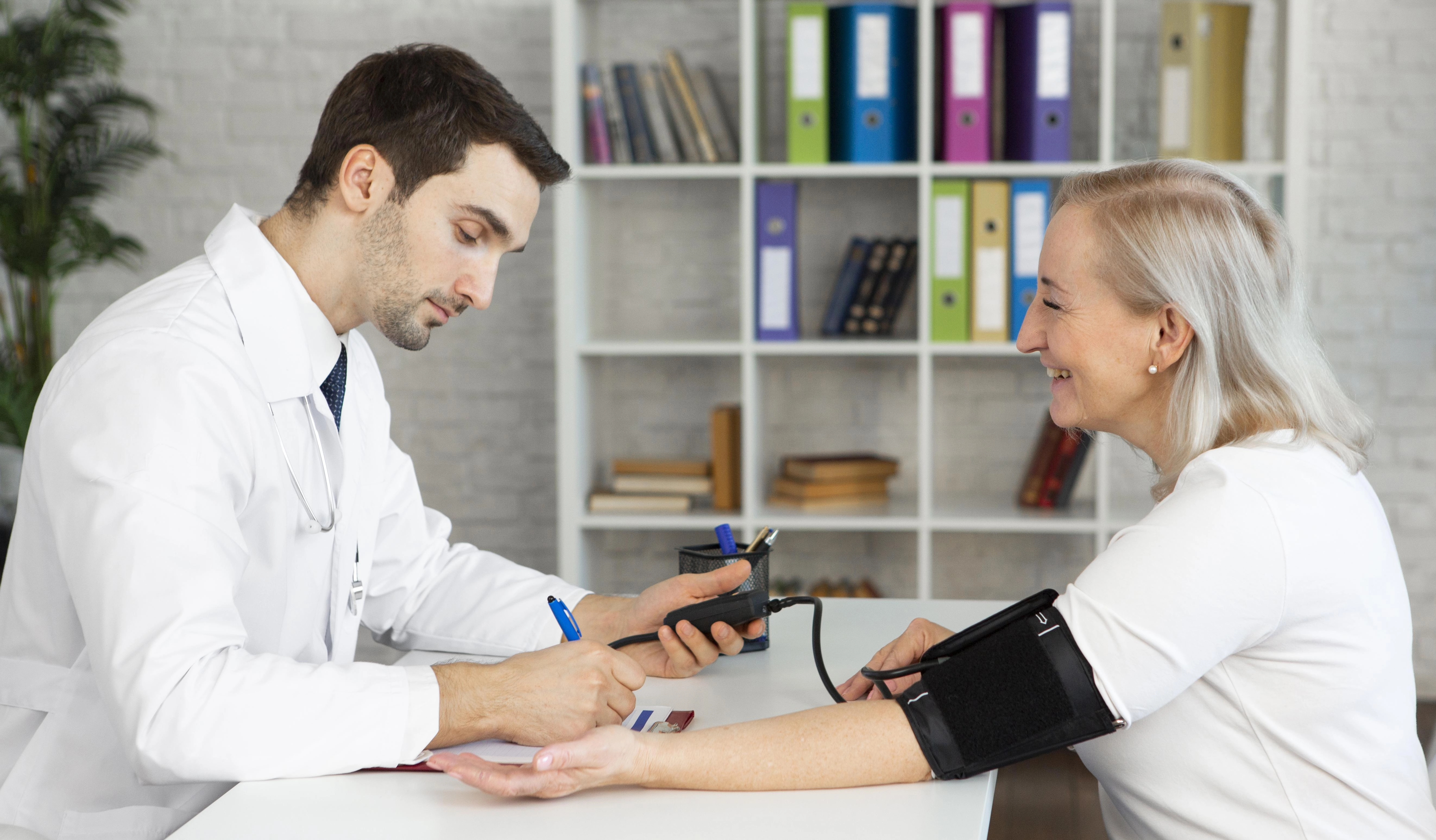 medium-shot-doctor-taking-blood-pressure