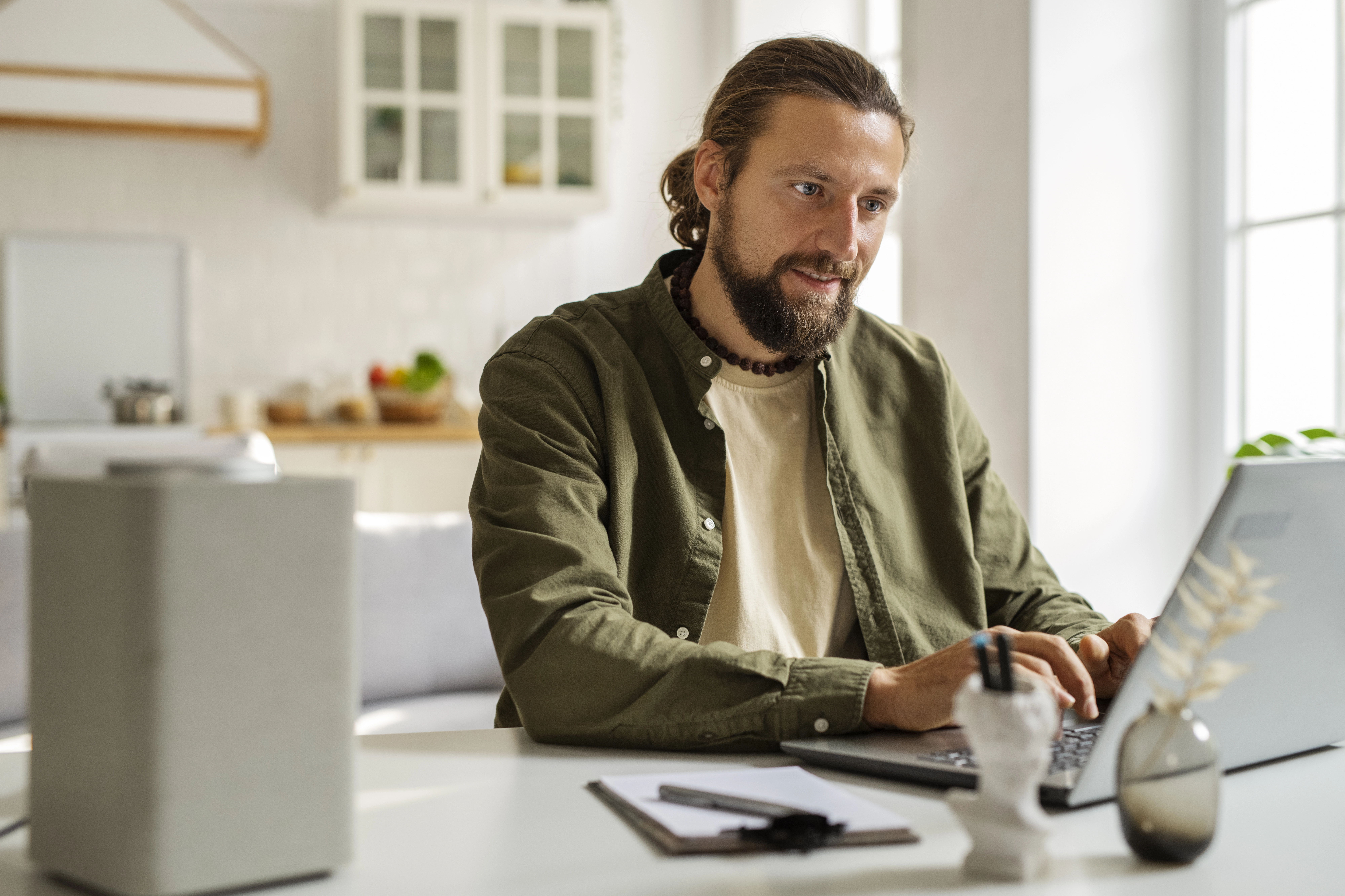 side-view-smiley-man-working-laptop