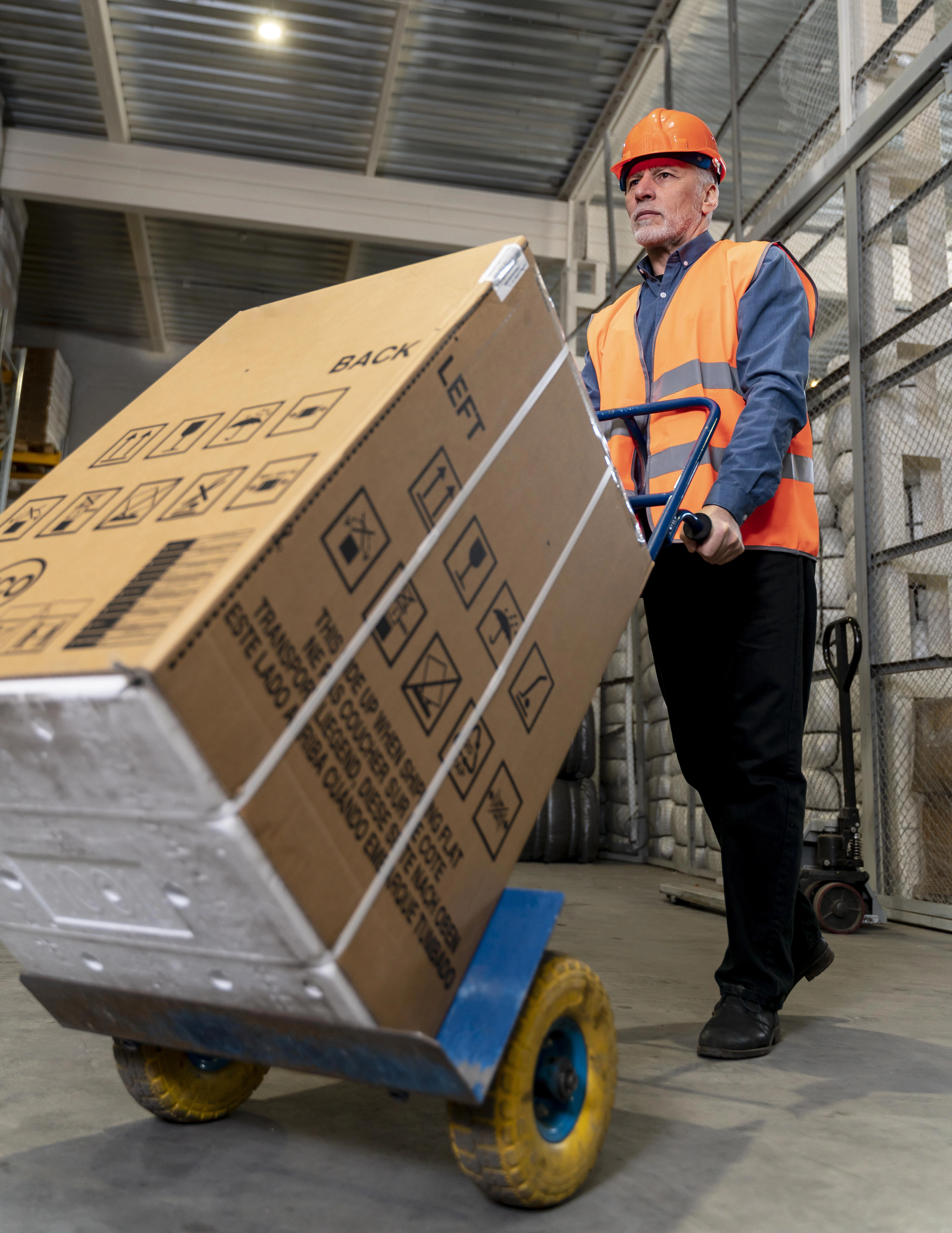 man-with-helmet-carrying-boxes
